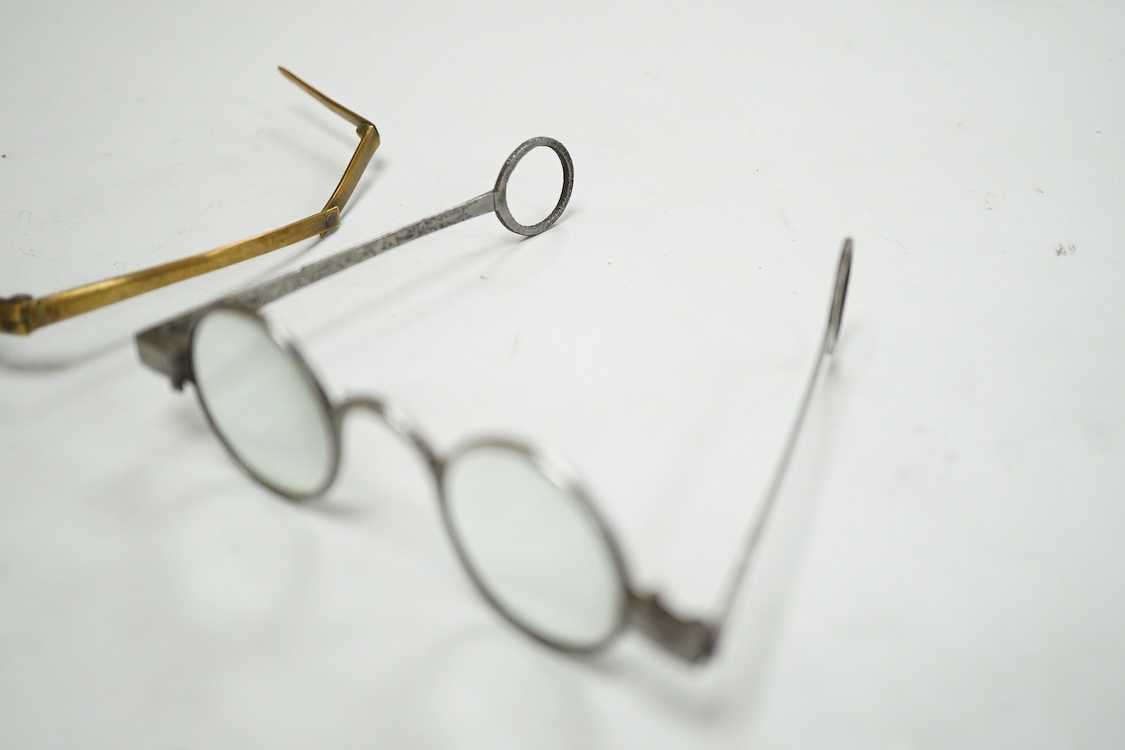 A pair of 18th century steel temple spectacles, a similar pair of iron spectacles, with written note dating them to 1796, and a pair of German? brass framed spectacles with green tinted lenses (3)